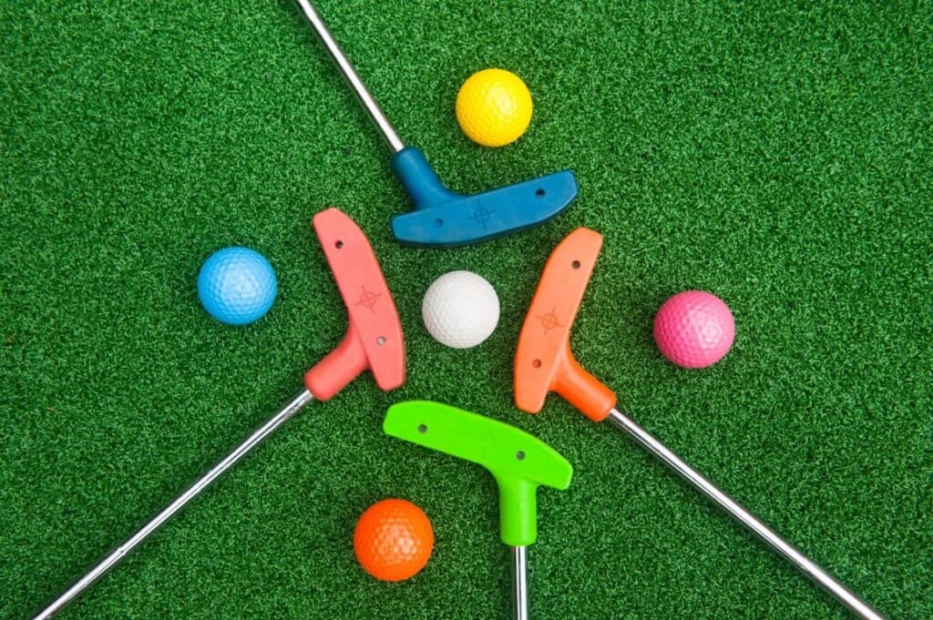 Colorful mini golf putters and balls
